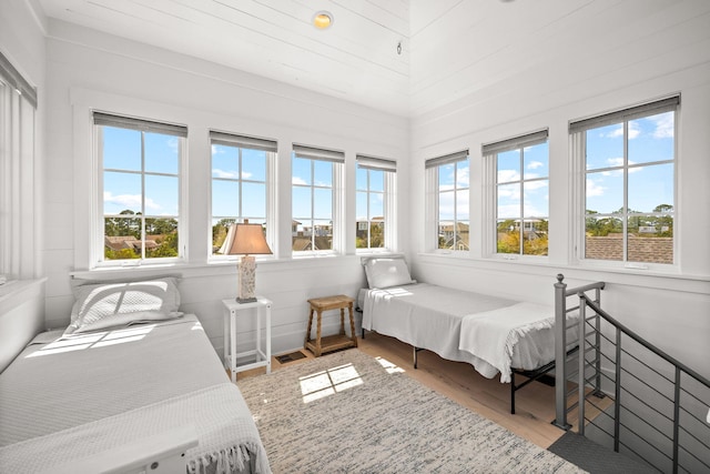 44 Tidepool Ln, Watersound, FL 32461 - bedroom with multiple windows and wood finished floors