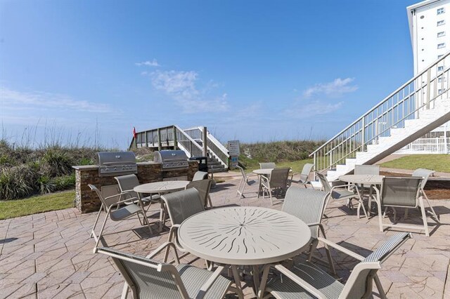 1700 Scenic Highway 98 Unit 207, Destin, FL 32541 - view of patio featuring stairway and outdoor dining space