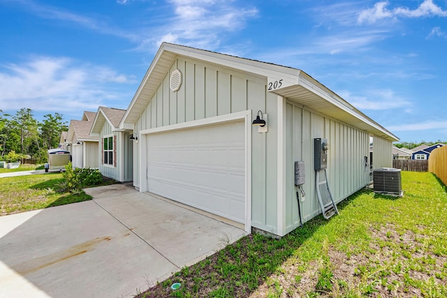 205 Laurel Hill St, Crestview, FL 32539 - view of home's exterior with board and batten siding, central air condition unit, an attached garage, and concrete driveway