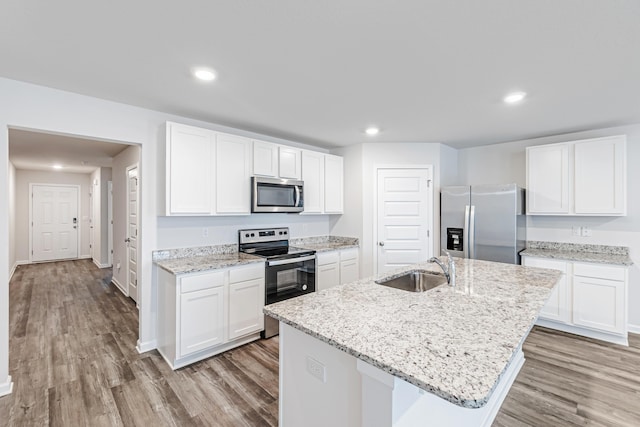 205 Laurel Hill St, Crestview, FL 32539 - kitchen with stainless steel appliances, a sink, light wood-style flooring, white cabinets, and recessed lighting