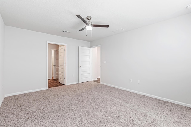 205 Laurel Hill St, Crestview, FL 32539 - unfurnished bedroom with dark carpet, baseboards, and a ceiling fan