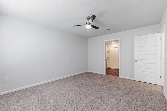205 Laurel Hill St, Crestview, FL 32539 - unfurnished bedroom with carpet, baseboards, connected bathroom, a ceiling fan, and a textured ceiling