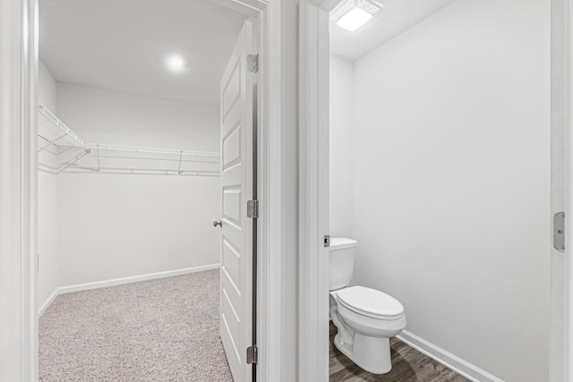 205 Laurel Hill St, Crestview, FL 32539 - bathroom featuring toilet, baseboards, and a walk in closet