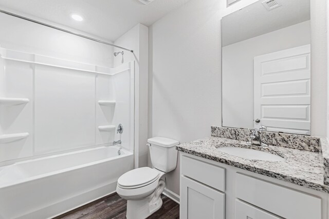 205 Laurel Hill St, Crestview, FL 32539 - bathroom with vanity, wood finished floors, tub / shower combination, toilet, and baseboards