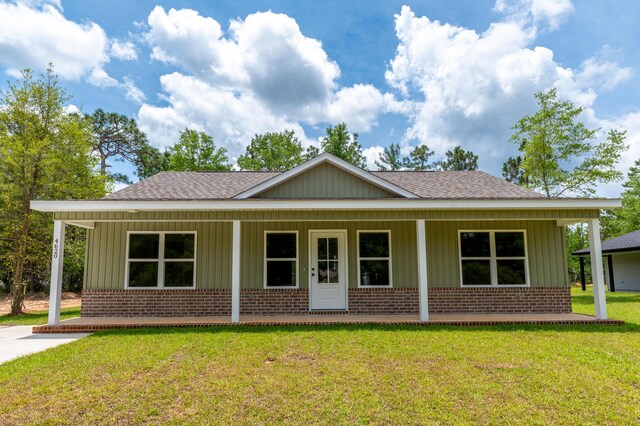4620 Eagle Way, Crestview, FL 32539 - view of front of house featuring brick siding, roof with shingles, a porch, and board and batten siding