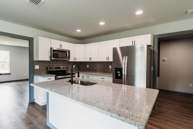 4618 Eagle Way, Crestview, FL 32539 - kitchen featuring appliances with stainless steel finishes, white cabinets, dark wood-style flooring, decorative backsplash, and recessed lighting