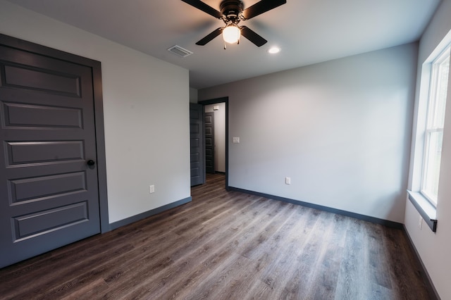 4618 Eagle Way, Crestview, FL 32539 - unfurnished bedroom with dark wood-style floors, multiple windows, recessed lighting, and ceiling fan