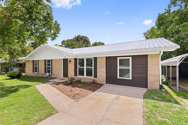 306 Forrest Pkwy, Crestview, FL 32539 - ranch-style home with a front yard, brick siding, and metal roof