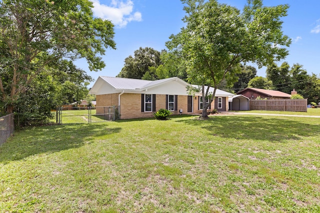 306 Forrest Pkwy, Crestview, FL 32539 - single story home featuring a gate, brick siding, metal roof, and a storage unit