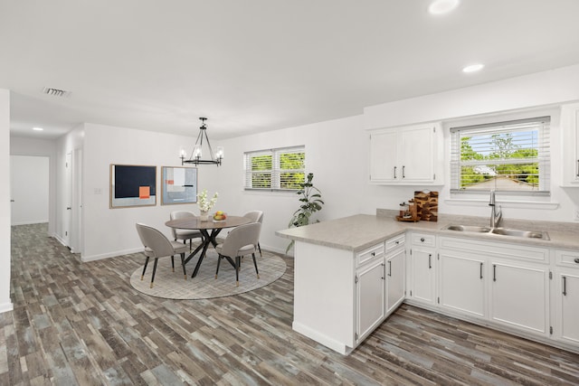 306 Forrest Pkwy, Crestview, FL 32539 - kitchen with a sink, a peninsula, white cabinetry, dark wood finished floors, and recessed lighting