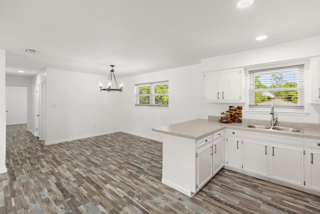 306 Forrest Pkwy, Crestview, FL 32539 - kitchen with a sink, a peninsula, healthy amount of natural light, dark wood finished floors, and recessed lighting