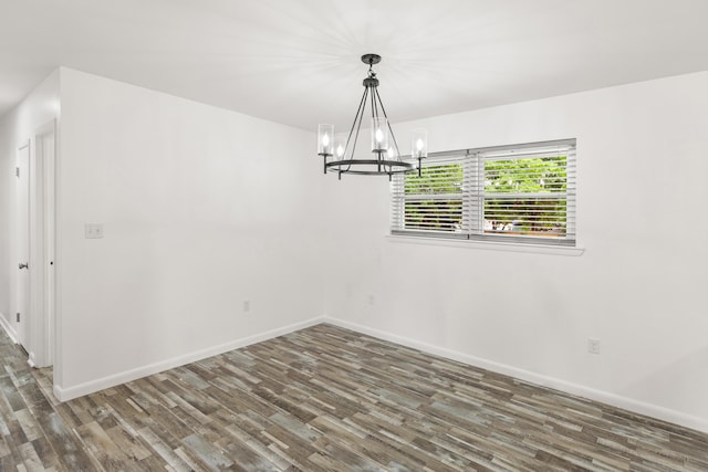 306 Forrest Pkwy, Crestview, FL 32539 - spare room with a chandelier, wood finished floors, and baseboards