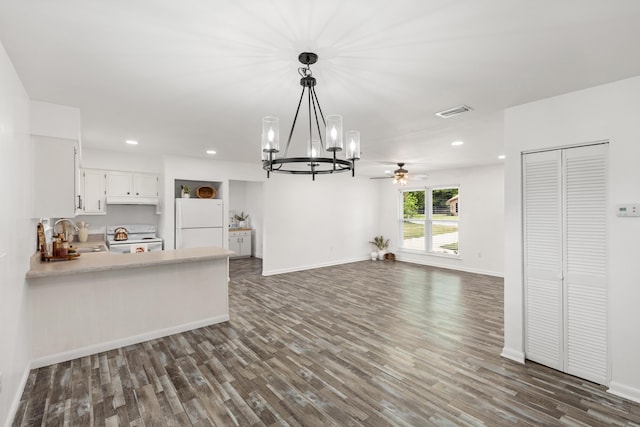 306 Forrest Pkwy, Crestview, FL 32539 - kitchen featuring white appliances, a chandelier, dark wood-type flooring, light countertops, and a peninsula
