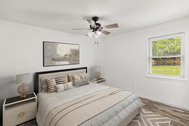 306 Forrest Pkwy, Crestview, FL 32539 - bedroom with wood finished floors, baseboards, and ceiling fan