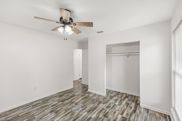306 Forrest Pkwy, Crestview, FL 32539 - unfurnished bedroom with wood finished floors, a closet, baseboards, and a ceiling fan