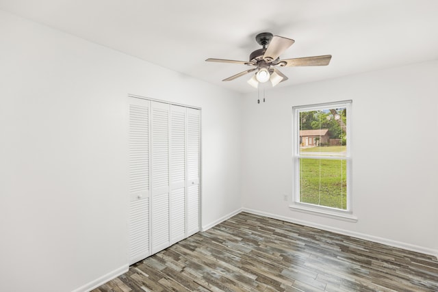 306 Forrest Pkwy, Crestview, FL 32539 - unfurnished bedroom with wood finished floors, a closet, baseboards, and a ceiling fan
