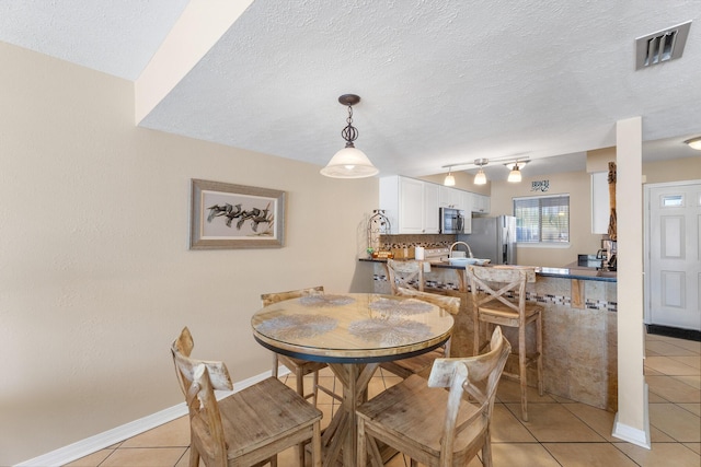 21514 Front Beach Rd, Panama City Beach, FL 32413 - dining space featuring light tile patterned flooring and a textured ceiling