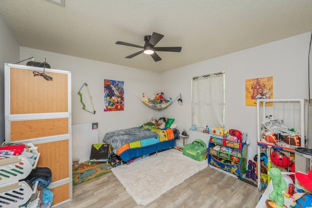 6229 Flash Ln, Crestview, FL 32536 - bedroom featuring wood finished floors, a ceiling fan, and a textured ceiling