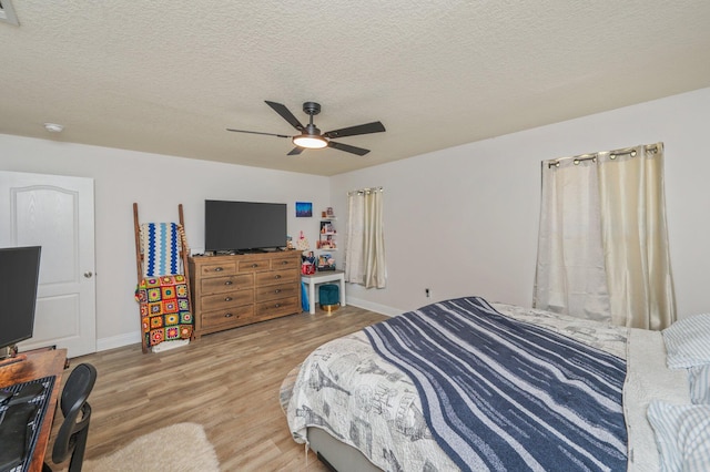 6229 Flash Ln, Crestview, FL 32536 - bedroom featuring light wood-style floors, baseboards, a textured ceiling, and a ceiling fan
