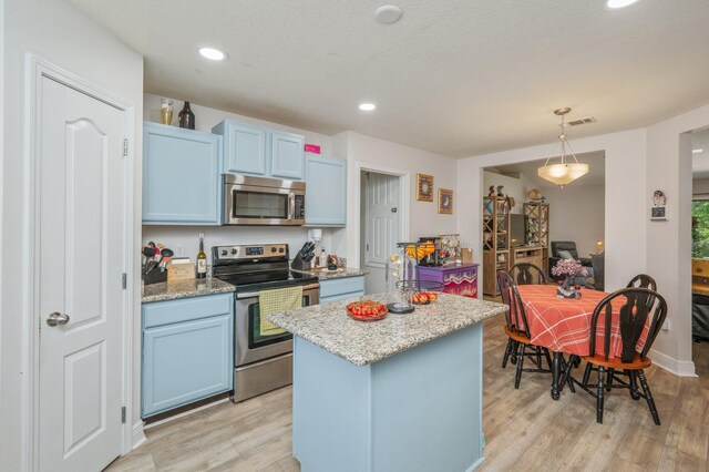 6229 Flash Ln, Crestview, FL 32536 - kitchen with stainless steel appliances, blue cabinets, light wood finished floors, a kitchen island, and recessed lighting