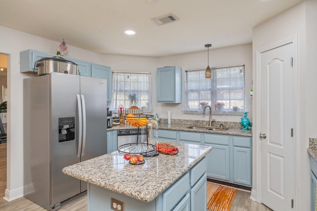 6229 Flash Ln, Crestview, FL 32536 - kitchen with stainless steel refrigerator with ice dispenser, a sink, blue cabinetry, light wood finished floors, and recessed lighting