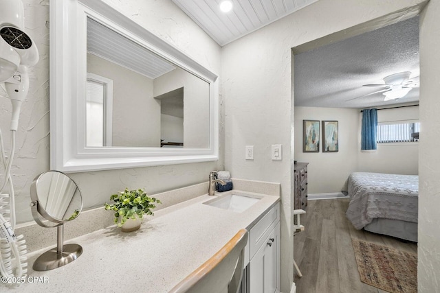 17155 Front Beach Rd Unit W405, Panama City Beach, FL 32413 - ensuite bathroom featuring wood finished floors, vanity, ceiling fan, and baseboards