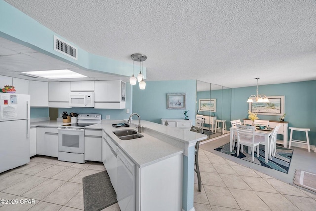 17155 Front Beach Rd Unit W405, Panama City Beach, FL 32413 - kitchen with white appliances, a sink, a peninsula, light tile patterned floors, and a textured ceiling