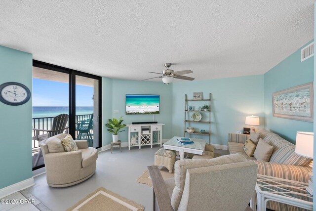 17155 Front Beach Rd Unit W405, Panama City Beach, FL 32413 - living area with a textured ceiling, ceiling fan, and baseboards