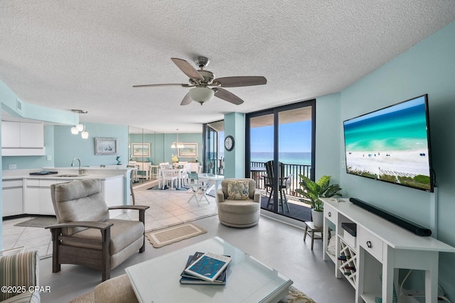 17155 Front Beach Rd Unit W405, Panama City Beach, FL 32413 - living area featuring ceiling fan, expansive windows, and a textured ceiling