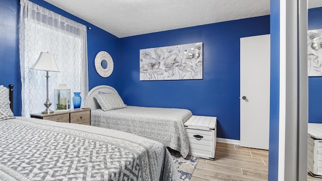 17642 Front Beach Rd Unit G4, Panama City Beach, FL 32413 - bedroom featuring wood finished floors, baseboards, and a textured ceiling