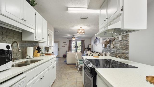 17642 Front Beach Rd Unit G4, Panama City Beach, FL 32413 - kitchen with black electric range, a sink, decorative backsplash, light countertops, and dishwasher