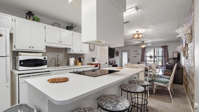 17642 Front Beach Rd Unit G4, Panama City Beach, FL 32413 - kitchen featuring a sink, white appliances, a textured ceiling, white cabinets, and light countertops