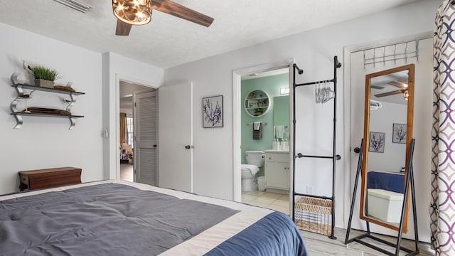 17642 Front Beach Rd Unit G4, Panama City Beach, FL 32413 - bedroom with a textured ceiling, connected bathroom, and a ceiling fan
