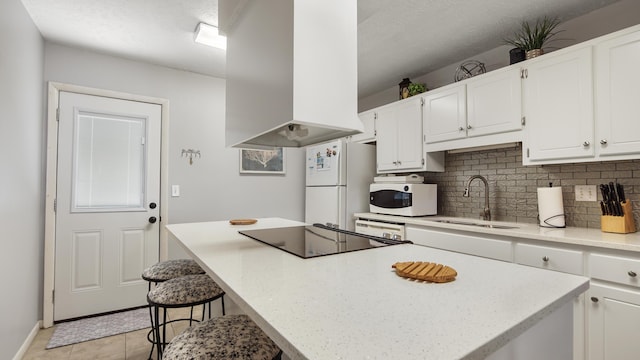 17642 Front Beach Rd Unit G4, Panama City Beach, FL 32413 - kitchen featuring a sink, white appliances, wall chimney range hood, decorative backsplash, and white cabinets