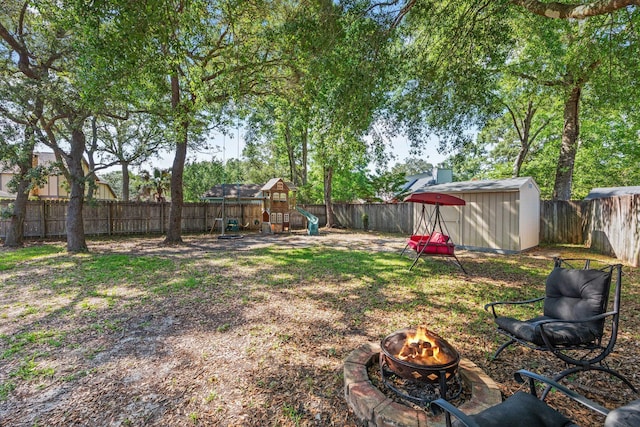 207 Oakwood Cir, Niceville, FL 32578 - fenced backyard featuring an outdoor fire pit and a playground