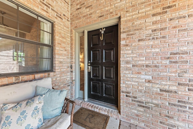 207 Oakwood Cir, Niceville, FL 32578 - view of exterior entry featuring brick siding and covered porch