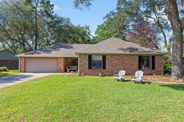 207 Oakwood Cir, Niceville, FL 32578 - ranch-style house featuring driveway, brick siding, roof with shingles, an attached garage, and a front lawn