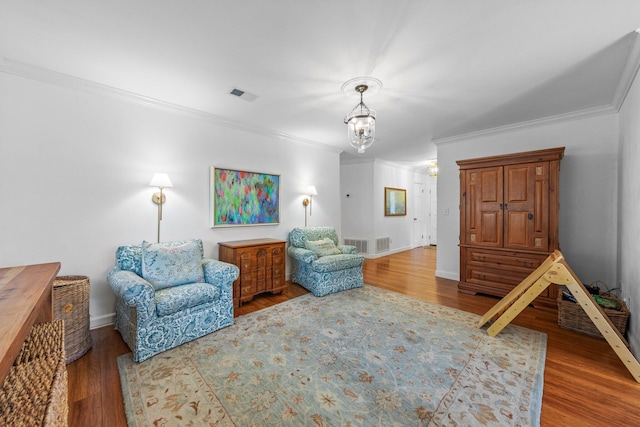 207 Oakwood Cir, Niceville, FL 32578 - living area with ornamental molding, wood finished floors, a chandelier, and baseboards