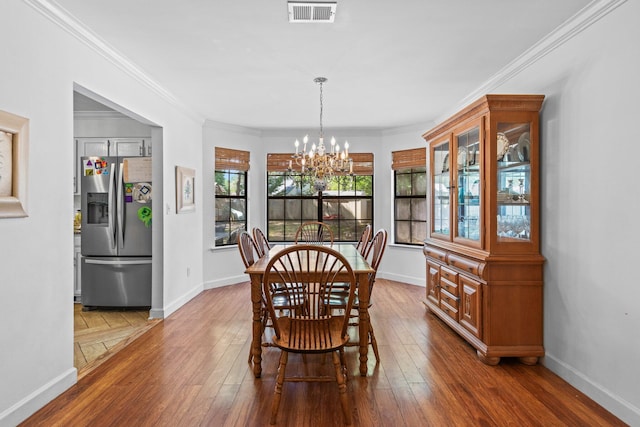 207 Oakwood Cir, Niceville, FL 32578 - dining area featuring a chandelier, wood-type flooring, baseboards, and ornamental molding