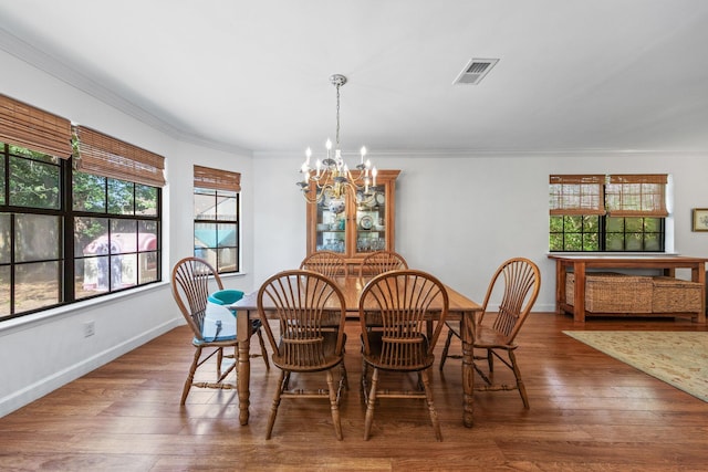 207 Oakwood Cir, Niceville, FL 32578 - dining area with a chandelier, healthy amount of natural light, crown molding, and wood finished floors