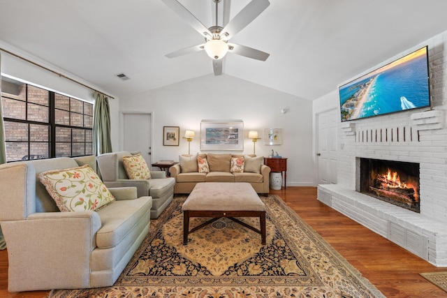 207 Oakwood Cir, Niceville, FL 32578 - living room featuring vaulted ceiling, a brick fireplace, wood finished floors, a ceiling fan, and baseboards
