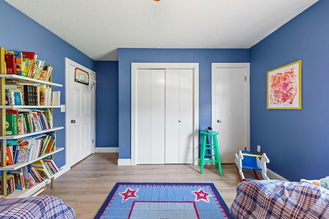 207 Oakwood Cir, Niceville, FL 32578 - bedroom with wood finished floors, baseboards, and a closet