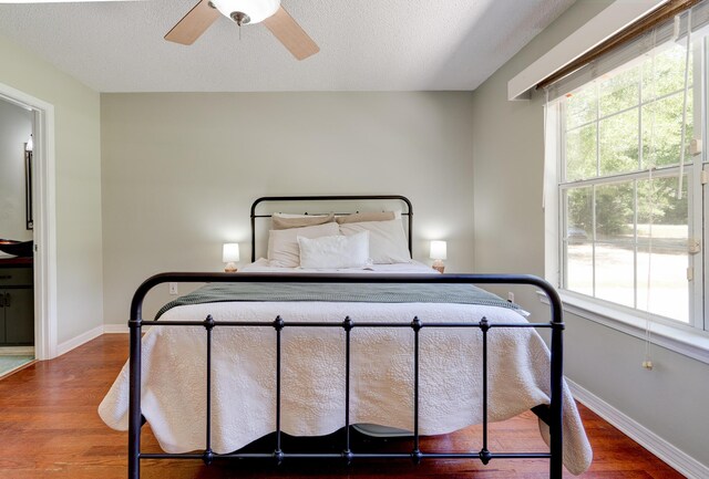 4236 Edge Perry Rd, Crestview, FL 32539 - bedroom featuring wood finished floors, baseboards, a textured ceiling, and ceiling fan