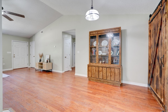 4236 Edge Perry Rd, Crestview, FL 32539 - living area featuring lofted ceiling, ceiling fan, a barn door, and light wood-type flooring