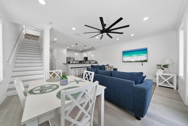 142 Southfields Rd, Panama City Beach, FL 32413 - dining space featuring light wood finished floors, ceiling fan, stairs, ornamental molding, and baseboards