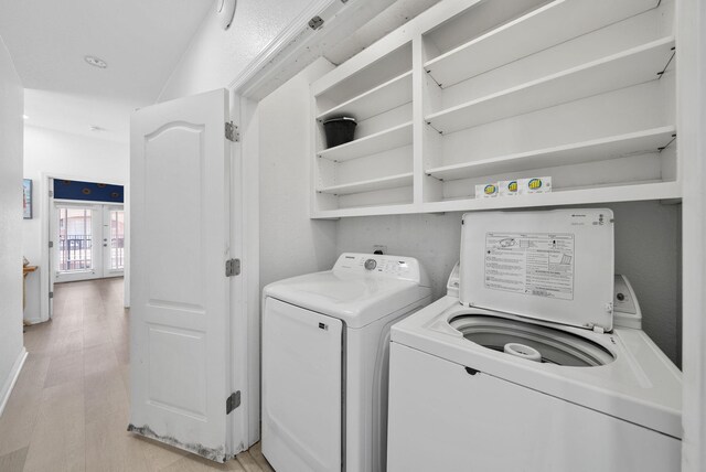 142 Southfields Rd, Panama City Beach, FL 32413 - laundry area with washing machine and dryer, light wood finished floors, and french doors