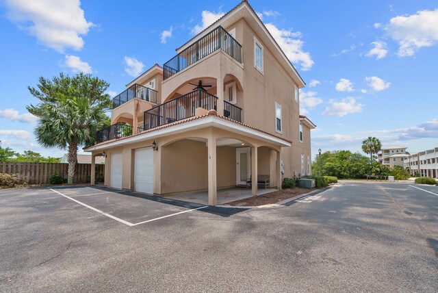142 Southfields Rd, Panama City Beach, FL 32413 - view of property featuring central AC and uncovered parking