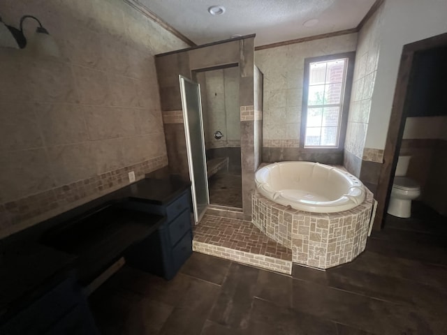 4932 Joiner Cir, Milton, FL 32583 - bathroom featuring ornamental molding, tile walls, a garden tub, a shower stall, and toilet