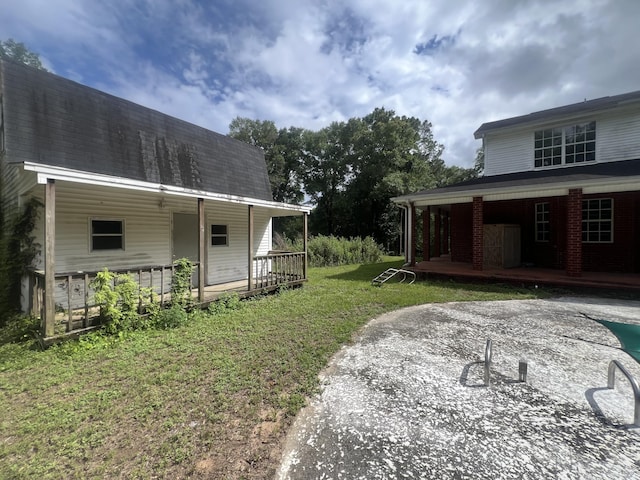 4932 Joiner Cir, Milton, FL 32583 - view of grassy yard featuring covered porch