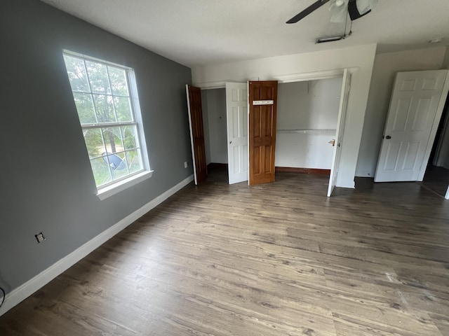 4932 Joiner Cir, Milton, FL 32583 - unfurnished bedroom featuring wood finished floors, baseboards, a closet, and ceiling fan